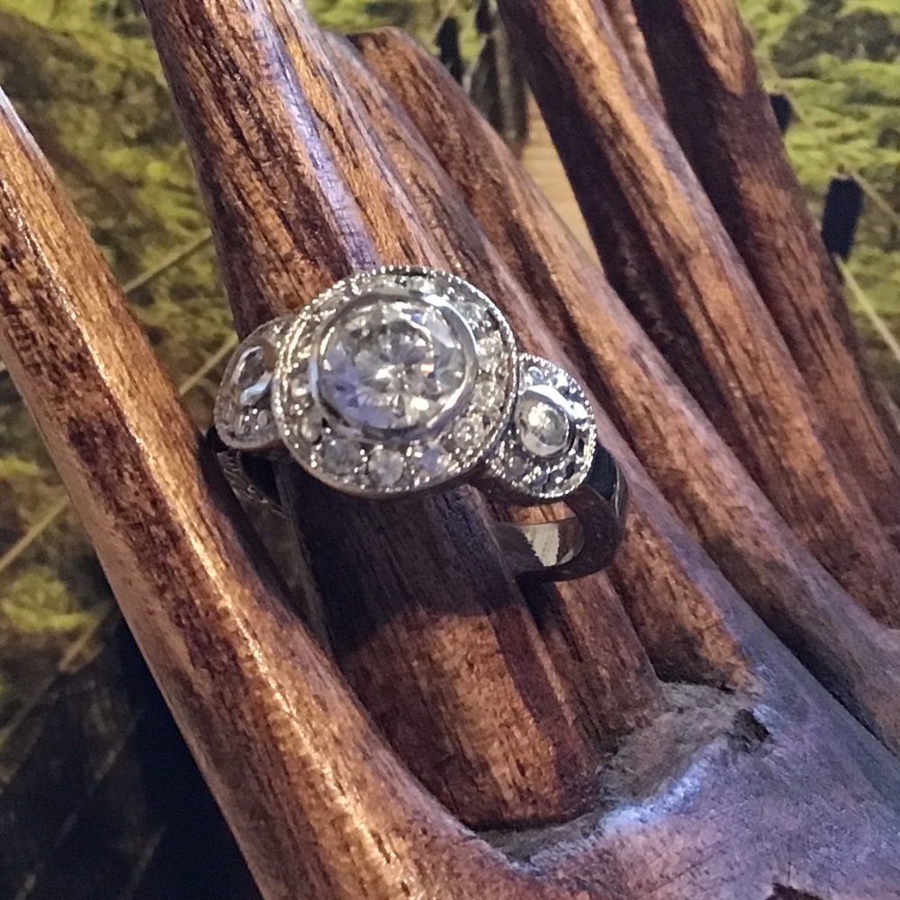 Costume jewelry ring with cut crystal stones and etching on band